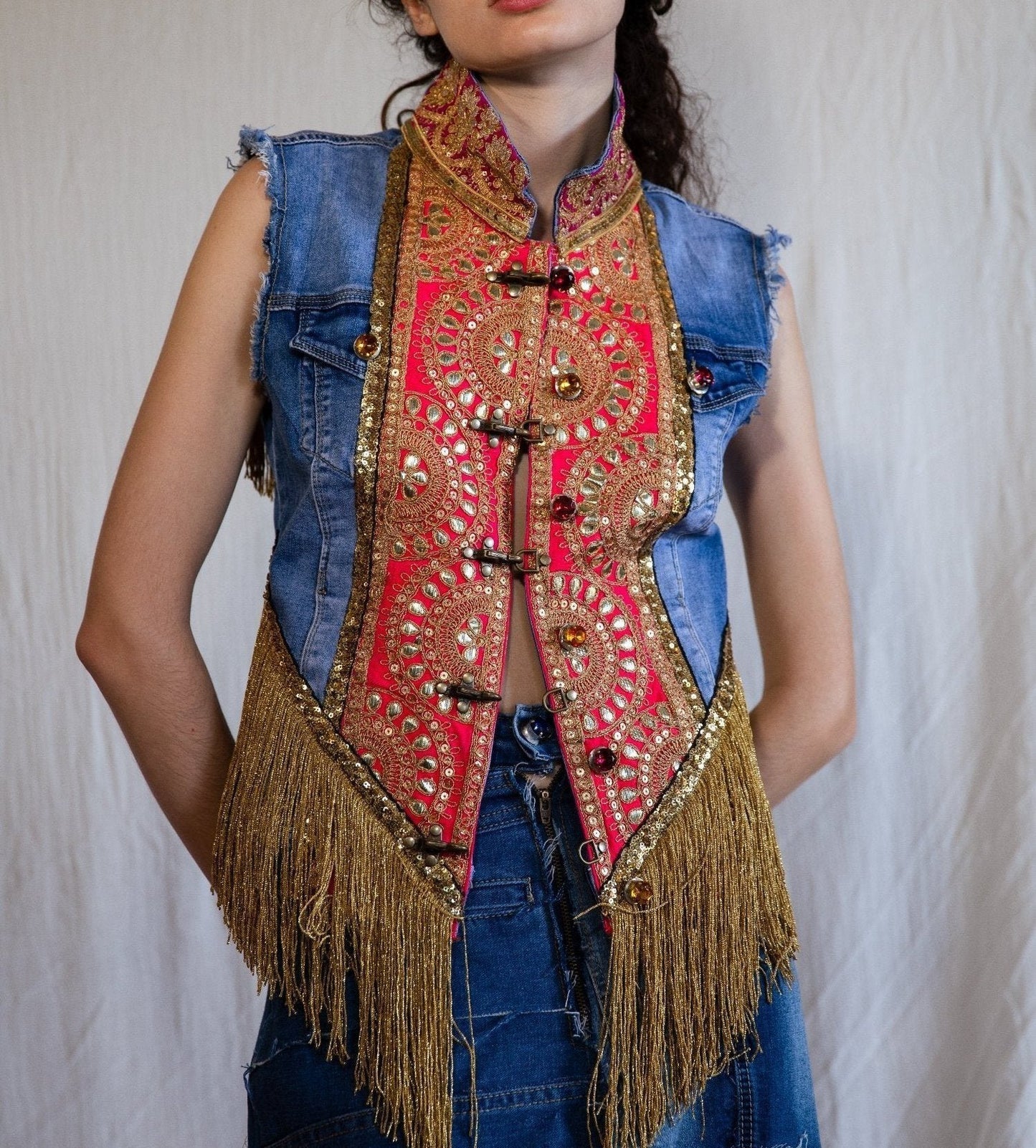 B.292 Denim vest with fuchsia embroideries and gold fringes