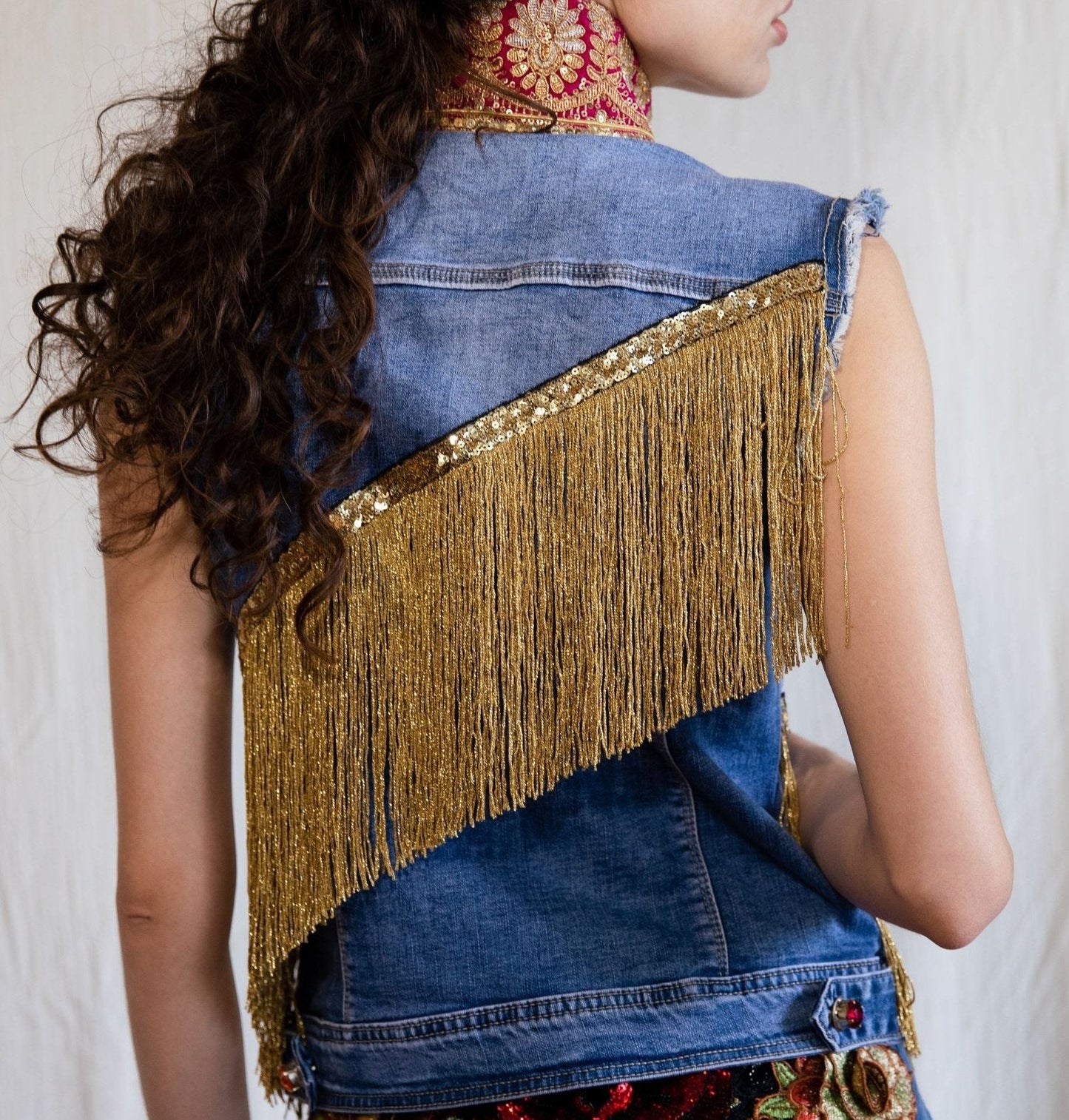 B.292 Denim vest with fuchsia embroideries and gold fringes