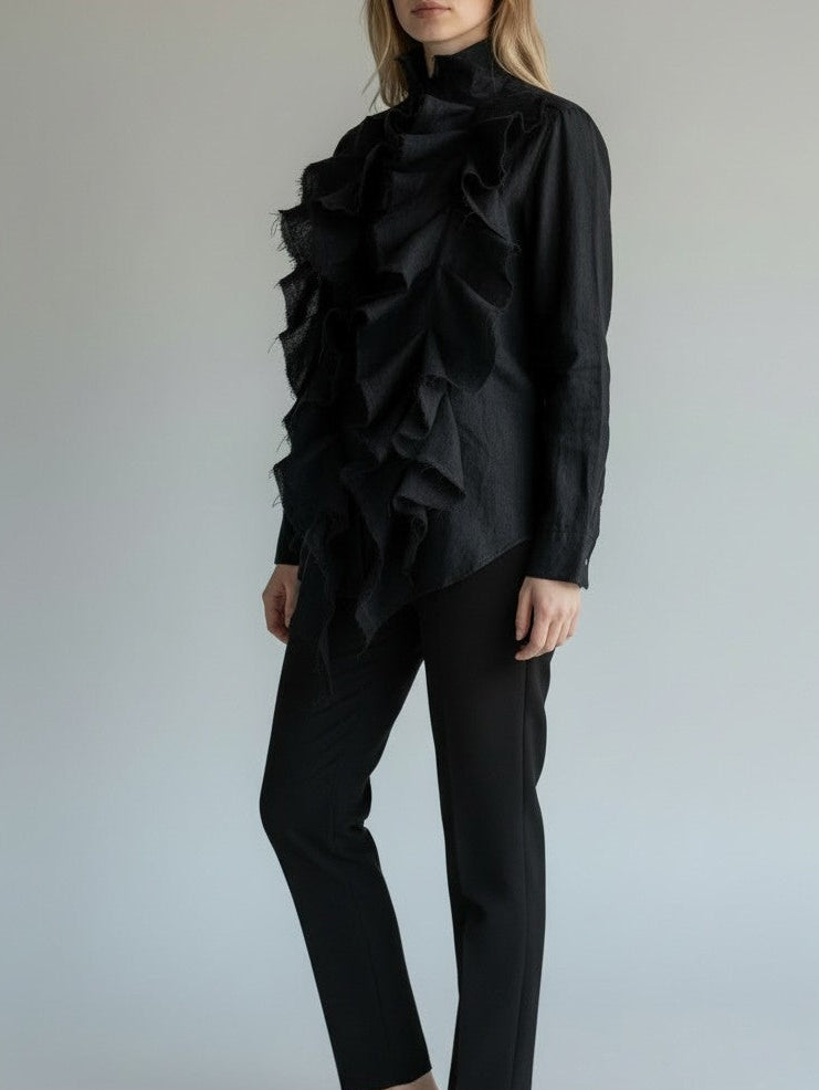 Person wearing a black ruffled shirt